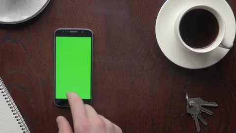 Hand making different touch gestures on the green screen of a phone Stock-Footage 75459107