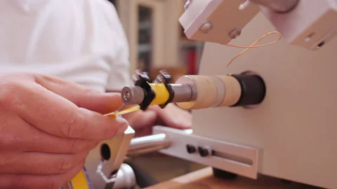 Hand making electronic component on coil winding machine - camera orbit Video stock 139743712