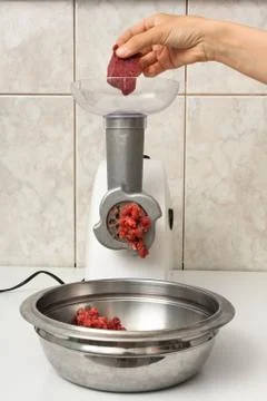 Hand making forcemeat with meat grinder Stock Photos