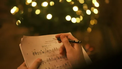 Hand making notes on music notes Stock Footage 296773109