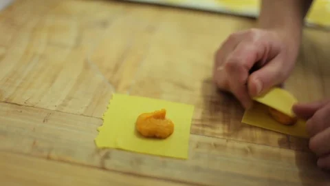 Hand making Pasta Ripiena in kitchen Stock Footage 107570056