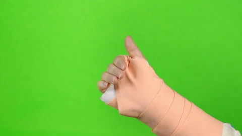 Hand making physical therapy to broken wrist from accident isolated on gree.. Stock Footage 235416649