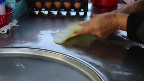 Hand making roti from flour and cheese in metal pan and hot oil Stock Footage 141305991