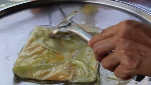 Hand making roti from flour and cheese in metal pan and hot oil Stock Footage 141306031