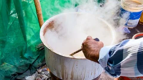 Hand Making Tea In A Large Boiling Pot At A Traditional Food Stall Stock Photos