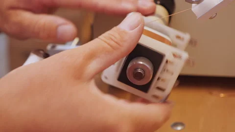 Hand making a transformer using coil winding machine - close up Stock Footage 139514789