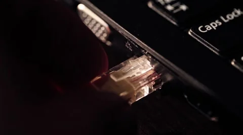 Hand male - a system administrator insert into the computer LAN RJ45 connector Stock Footage 47781484