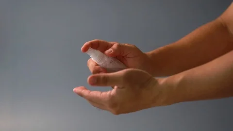Hand of man applying alcohol spray to prevent spread of germs. Stock Footage 126031257