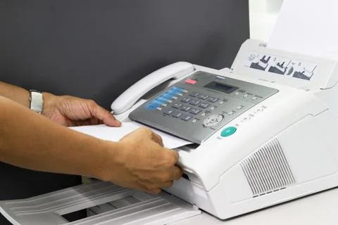 Hand man are using a fax machine in the office 库存照片