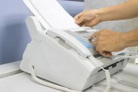 Hand man are using a fax machine in the office 스톡 사진