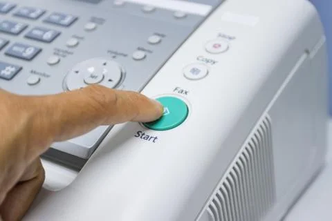 Hand man are using a fax machine in the office Stock Photos
