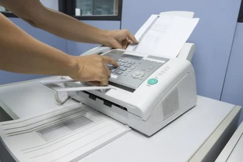 Hand man are using a fax machine in the office 스톡 사진