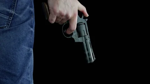 The hand of a man on a black background is holding a 380 caliber magnum pistol Stock Footage 145804802