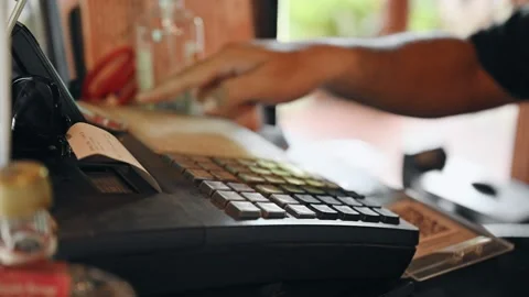 Hand of man checking bill with pressing on electronic cash register at counte Stock Footage 156917952