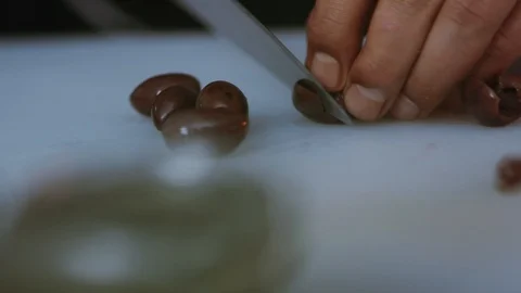 Hand man chef with knife cutting olive tasty slicing cook food kitchen meal Stock Footage 100303685