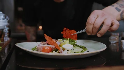 Hand man chefs prepare dishes making delicious food in a restaurant kitchen Stock Footage 100303608