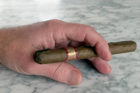 Hand of a man with a cigar on a marble table, smoking, people, men Stock Photos