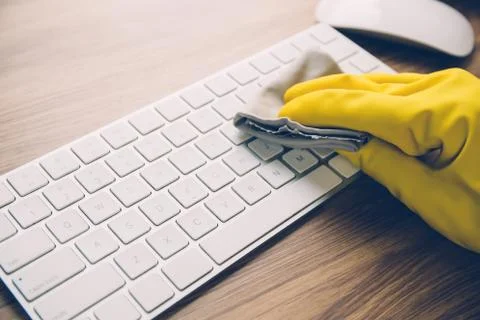 Hand of man cleaning keyboard computer with antibacterial for protect epidemi 写真素材