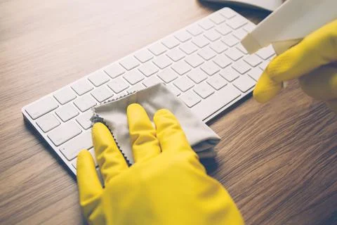 Hand of man cleaning keyboard computer with antibacterial for protect epide.. Stock Photos