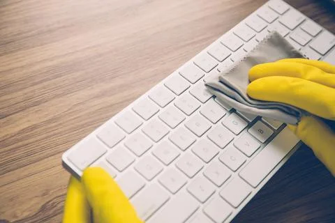 Hand of man cleaning keyboard computer with antibacterial for protect epide.. Stock Photos