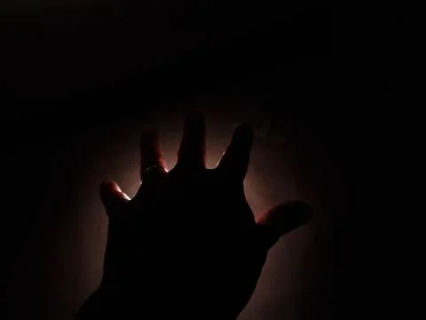 Hand man in the dark on the light Foto stock