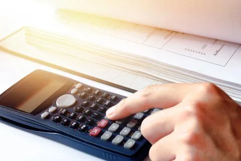 Hand man doing finances with using calculator at home office. Stock Photos