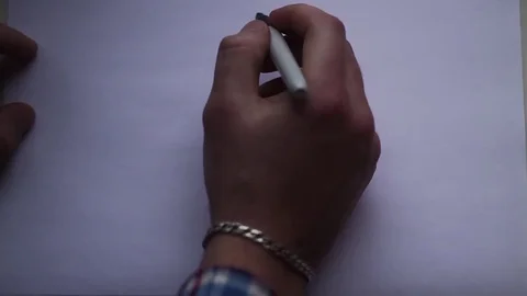 The hand of the man draws a smiley face on a white sheet of paper Stock Footage 70899007