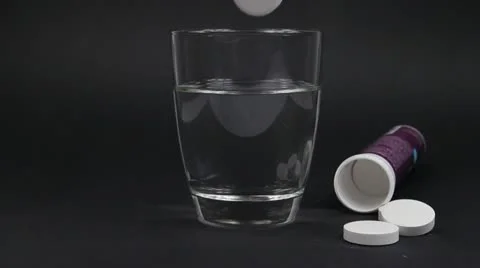 Hand of man drops an effervescent tablet into a glass of water Stock Footage 11067395