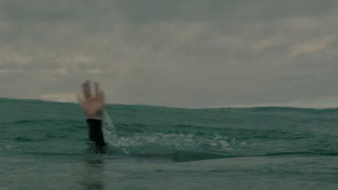 A hand of a man drowning Stock Footage 264019331