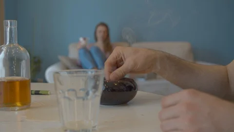 Hand of a man extinguishing a cigarette Stock Footage 129229793