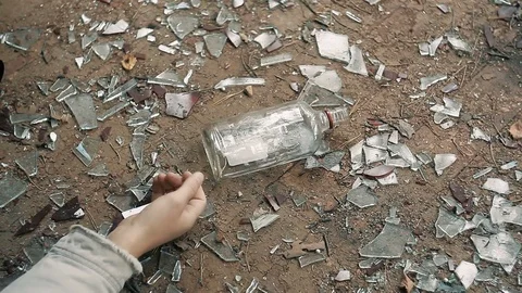 The hand of man on the floor reaching for the bottle of vodka Stock Footage 80718276