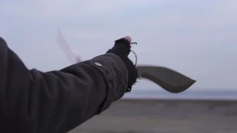 Hand of man in handmade gloves without fingers Throws up big machete and Stock Footage 102052867