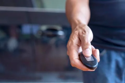 Hand man hode car remote for open the car. Soft focus and focus selective rem Stock Photos