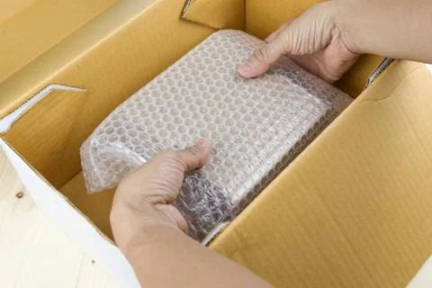 Hand of man hold bubble wrap, for protection parcel product cracked or insura Photos