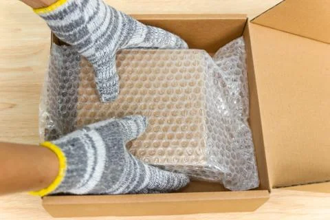 Hand of man hold bubble wrap, for protection parcel product cracked or insura 스톡 사진