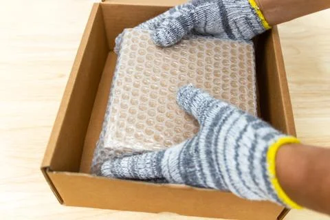 Hand of man hold bubble wrap, for protection parcel product cracked or insura Photos