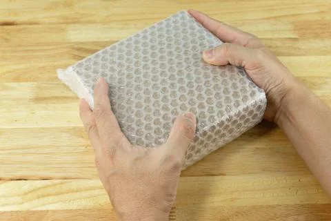 Hand of man hold bubble wrap, for protection parcel product cracked Stock Photos