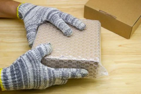 Hand of man hold bubble wrap, for protection parcel product cracked or insura Stock Photos