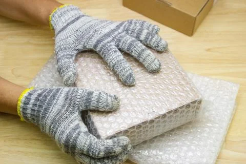 Hand of man hold bubble wrap, for protection parcel product cracked Stock Photos