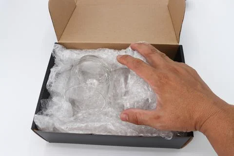 Hand of man hold bubble wrap cover glass for protection product cracked Photos