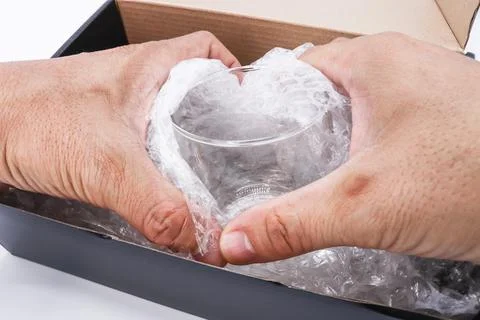 Hand of man hold bubble wrap cover glass for protection product cracked Photos