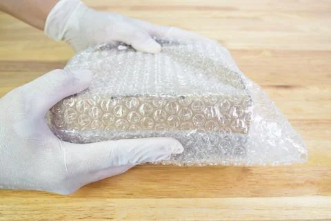 Hand of man hold bubble wrap, for protection parcel product cracked Photos