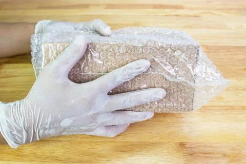 Hand of man hold bubble wrap, for protection parcel product cracked Photos