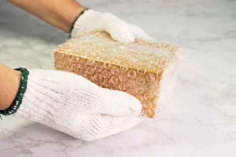 Hand of man hold bubble wrap, for protection parcel product cracked or insura 스톡 사진