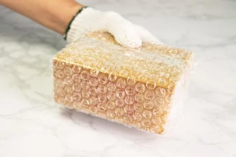 Hand of man hold bubble wrap, for protection parcel product Stock Photos