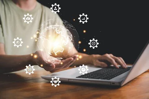 Hand of man hold virtual global with hologram using metaverse and internet co Stock Photos