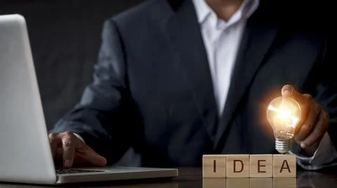 Hand man holding light bulb with text i d e a. Innovation idea and knowledge  Stock Photos