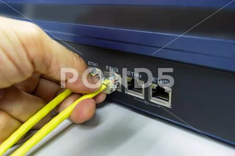 Hand of man holding The network cables to connect SFP module port Stock Photos