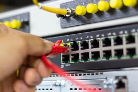 Hand of man holding The network cables to connect Lan port 스톡 사진