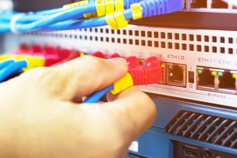 Hand of man holding The network cables to connect Lan port Photos
